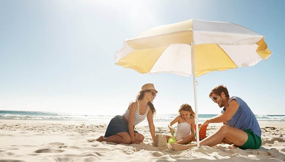 Family at the beach umbrella